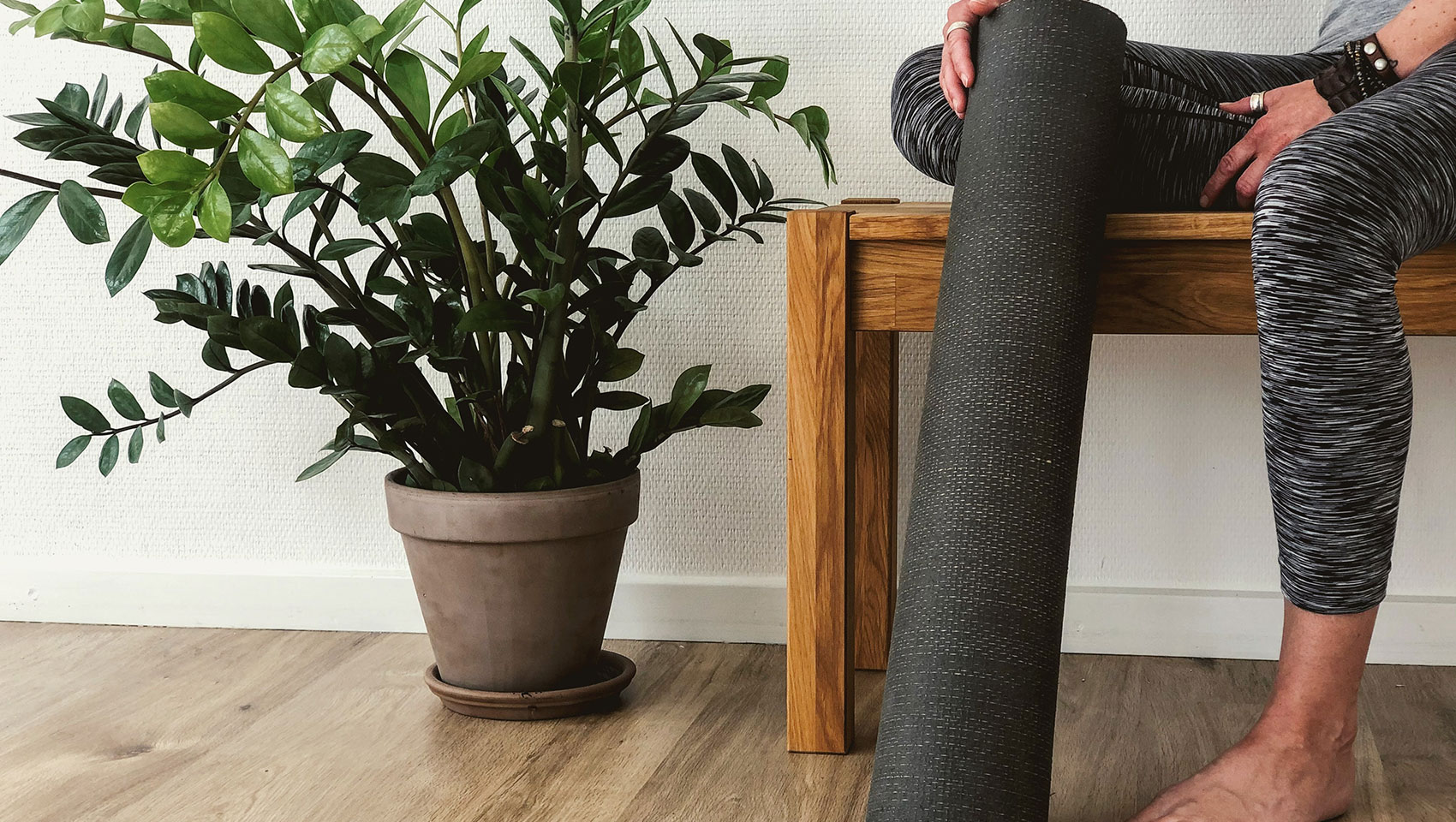 theta person holding yoga mat